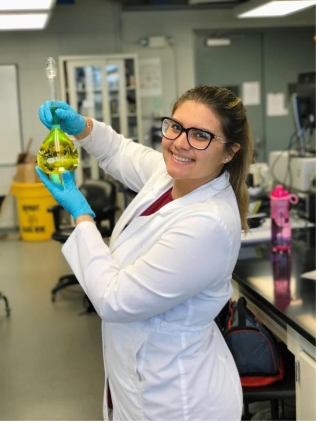 Nicole-Fernandez-Tejero in a lab holding a beaker