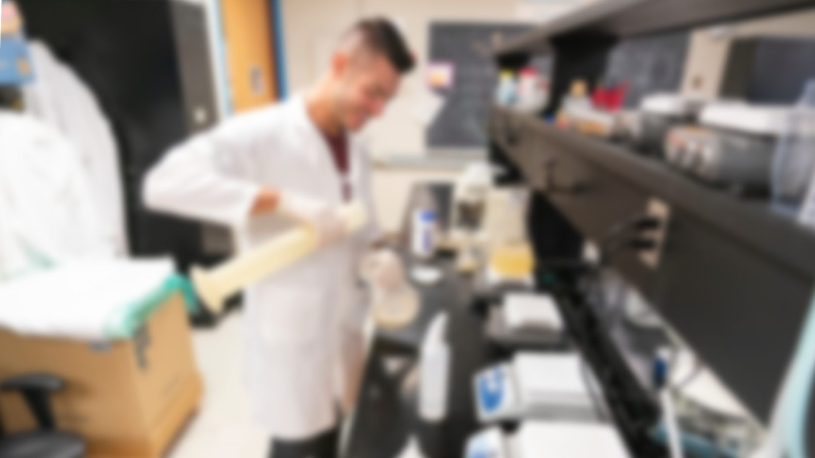blurred image of student working in laboratory