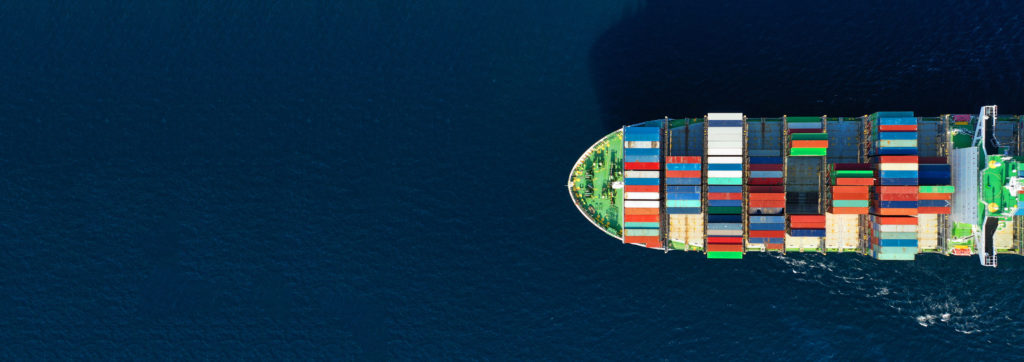 Aerial drone panoramic ultra wide photo of industrial container tanker ship cruising in open sea