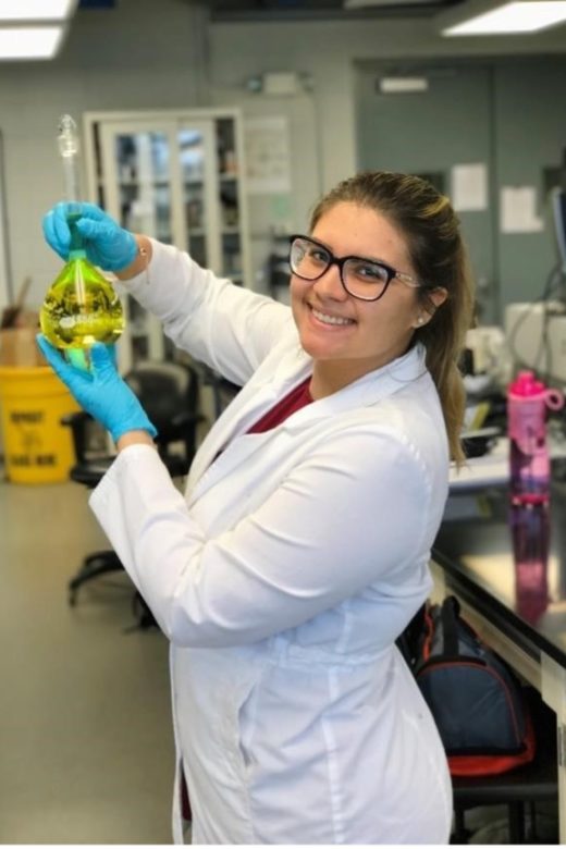 Nicole-Fernandez-Tejero in a lab holding a beaker