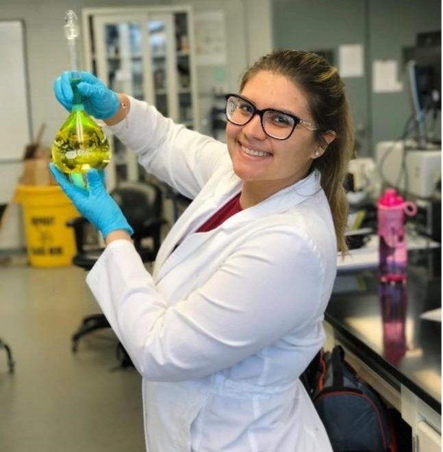 Nicole-Fernandez-Tejero in a lab holding a beaker